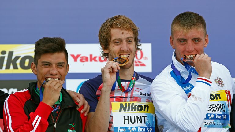 Gold medallist Gary Hunt of Great Britain (centre) with  Jonathan Paredes Bernal (left) and Artem Silchenko (right)