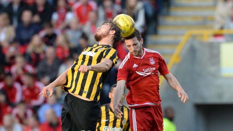 Aberdeen's Greame Shinnie (right) challenges Kairat Almaty's Stanislav Lunin (left) at Pittodrie