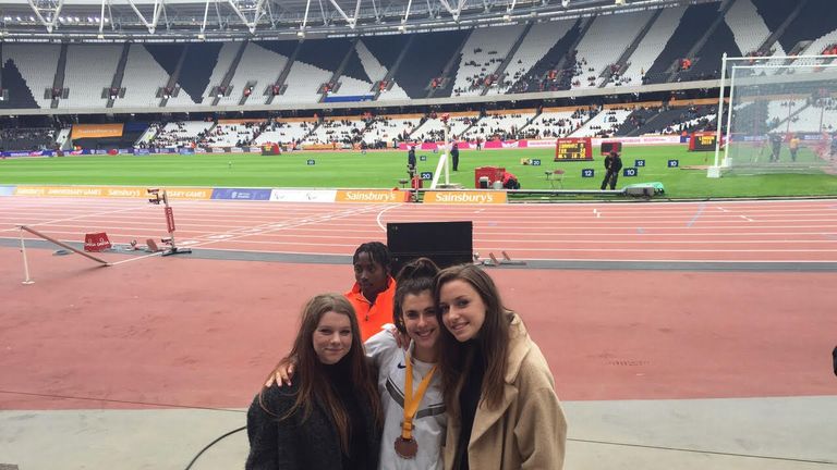 Olivia Breen shows off her Anniversary Games medal with friends