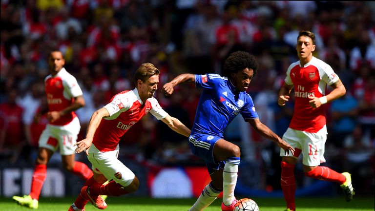 Willian (second right) and Nacho Monreal (second left) compete for the ball