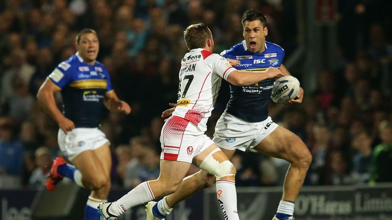 St Helens' Adam Quinlan (middle) attempts to tackle Joel Moon of Leeds Rhinos
