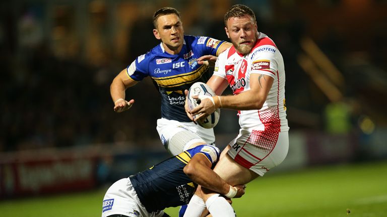 Josh Jones (right) is tackled by Kallum Watkins with Kevin Sinfield lurking