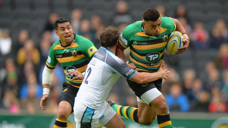 Luther Burrell of Northampton Saints is tackled by Adam Powell 