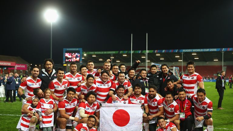 Japan pose for a team photograph after their win over the USA