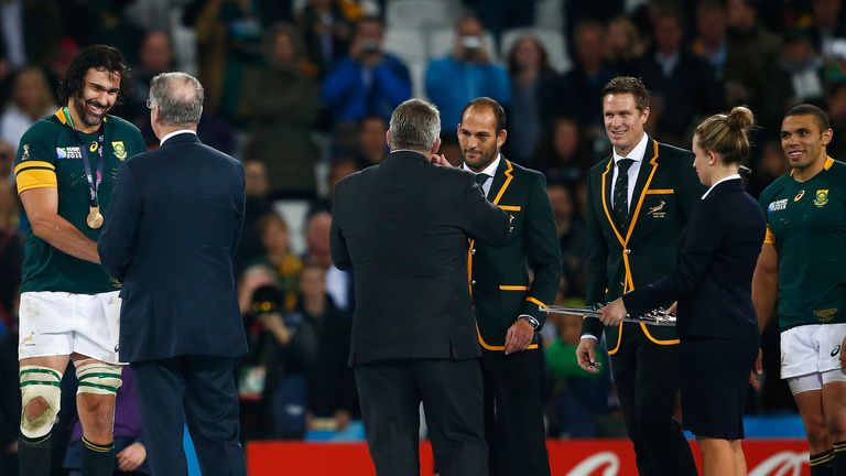 Chairman of the World Rugby Bernard Lapasset presens Captain Victor Matfield of South Africa with his bronze medal