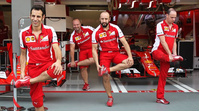 On the stretch: Ferrari mechanics warm up for their pitstop practice ahead of the Singapore GP - Picture by Mirko Stange, Sutton Images