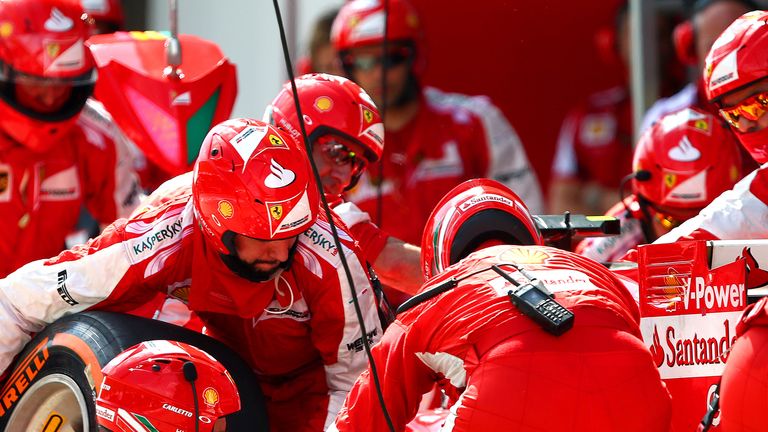 The men in red: Kimi Raikkonen's pit crew execute a change of tyres in Malaysia - Picture by Mark Thompson, Getty Images