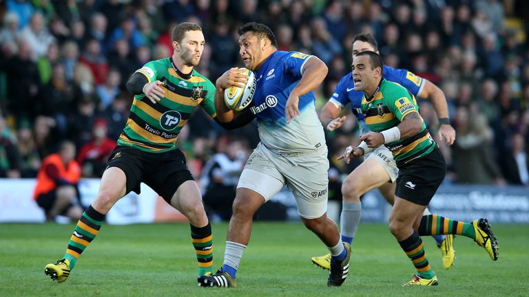 Billy Vunipola of Saracens tries to evade Northampton's George North