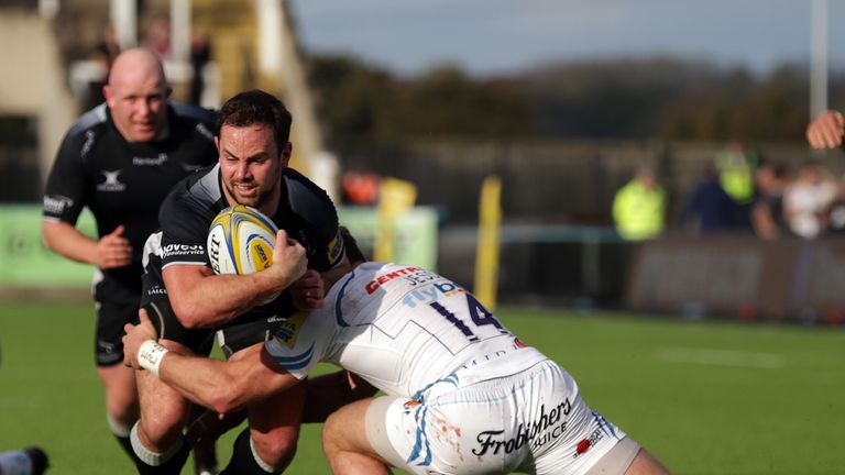 Newcastle scrum-half Michael Young is tackled by Matt Jess