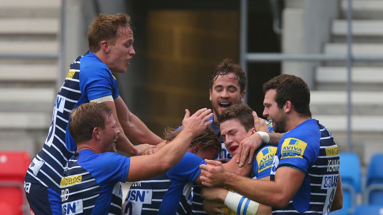 Sam James (second from right) is mobbed after scoring Sale's first try