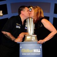Gary Anderson celebrates with his wife after winning a second consecutive world title