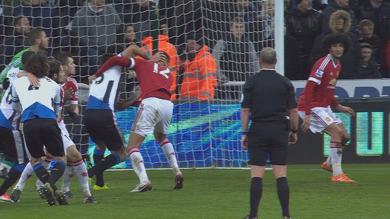 Chris Smalling grapples with Aleksandar Mitrovic