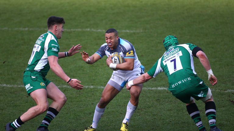 Marcus Watson of Newcastle Falcons looks to slip the tackle of London Irish's Luke Narraway (R) and Johnny Williams (L)