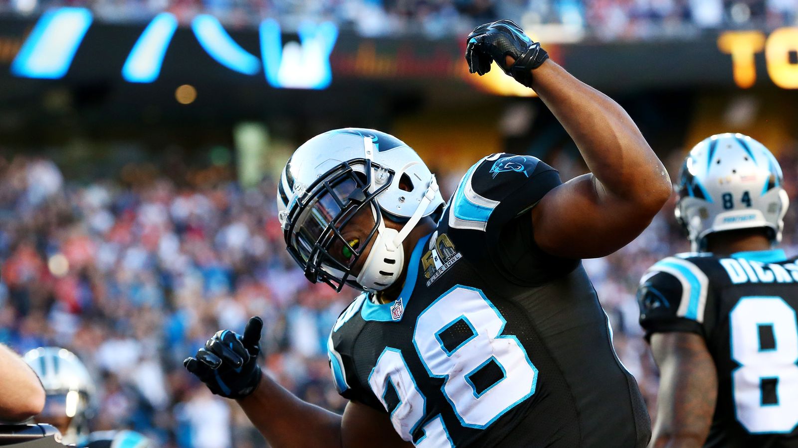 Carolina Panthers running back Jonathan Stewart (center) fights