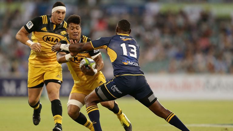 Ardie Savea of the Hurricanes is tackled by Tevita Kuridrani of the Brumbies