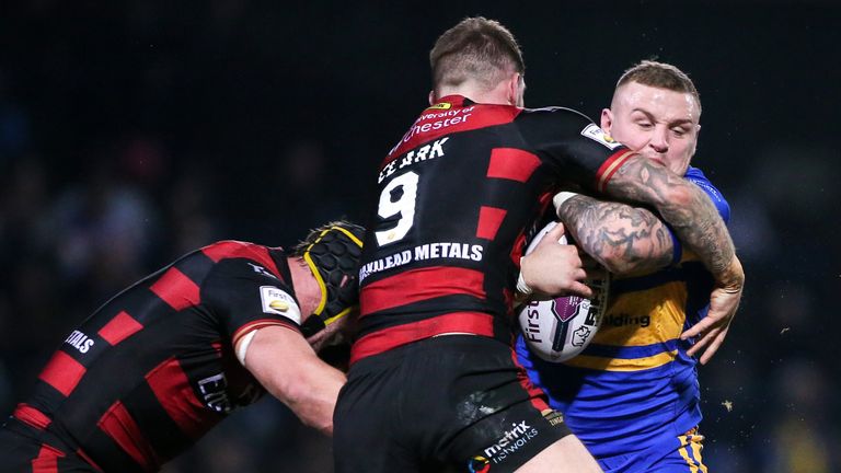 Leeds' Brad Singleton is tackled by Warrington's Chris Hill and Daryl Clark