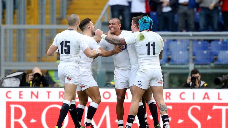 Jonathan Joseph celebrates with team-mates after scoring his second try against Italy in Rome