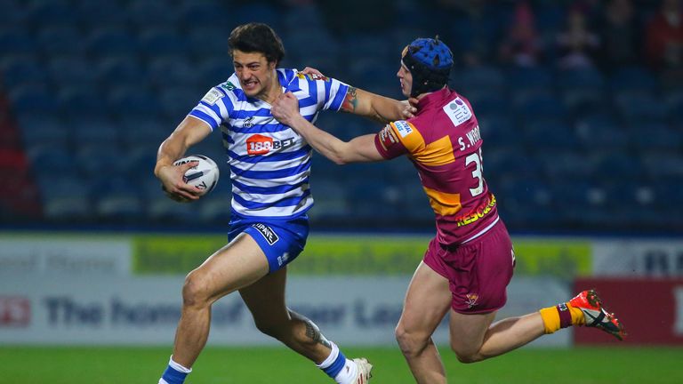 Wigan centre Anthony Gelling is tracked by Sam Wood