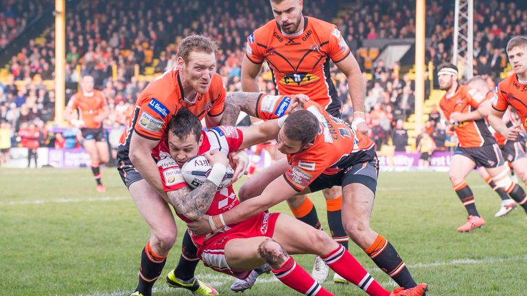 Salford's Gareth O'Brien is tackled by Joel Monaghan and Ben Crooks