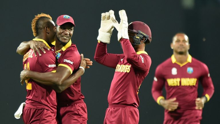 Sammy celebrates with teammates Andre Russell (left) and Denesh Ramdin