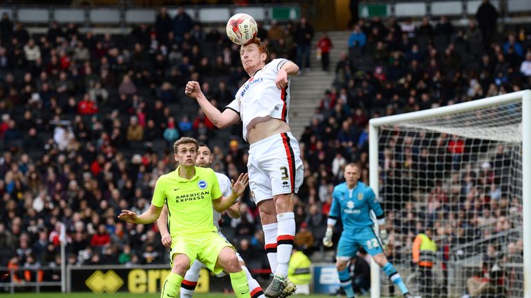 Dean Lewington wins a header for MK Dons