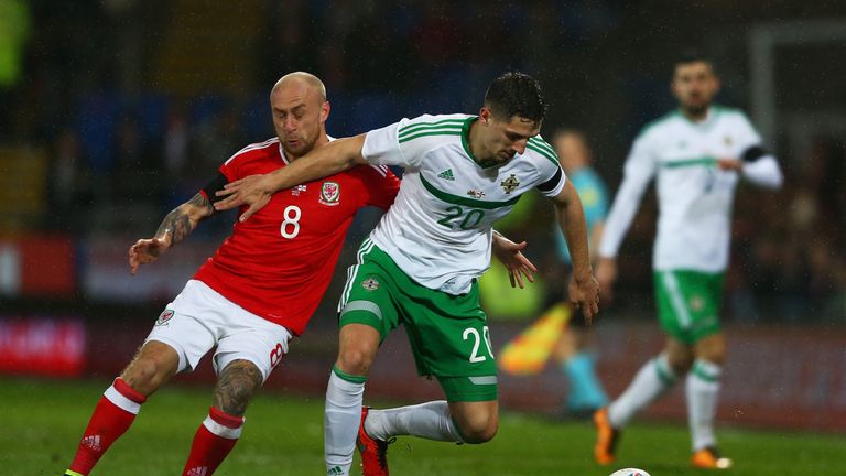 Craig Cathcart of Northern Ireland holds off David Cotterill of Wales during the international friendly
