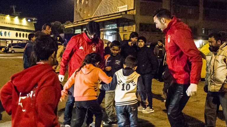 Roberto Jimenez and Chori Dominguez play football with refugee children