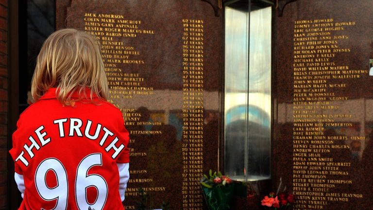 A Liverpool supporter pays her respects at the Hillsborough memorial