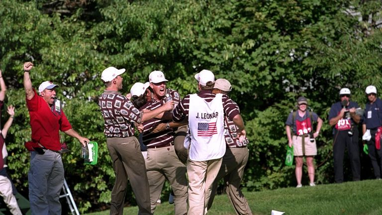 Justin Leonard was mobbed by the rest of the American team after holing a lengthy putt