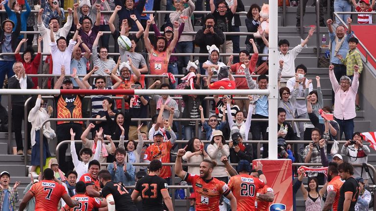 Sunwolves players and their supporters react after their first win in Super Rugby