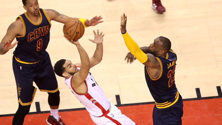 Cory Joseph of the Toronto Raptors shoots against James