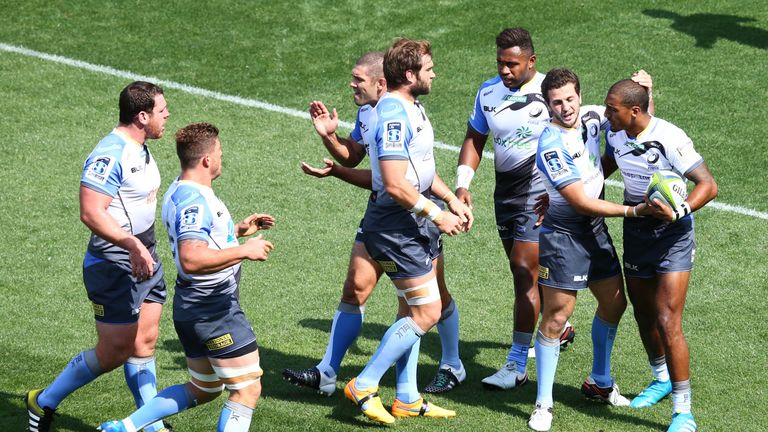 Marcel Brache (right) celebrates scoring his team's first try against Sunwolves