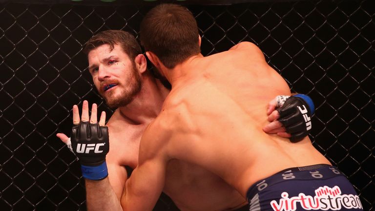 Michael Bisping appeals to the referee after being cut above the eye by Luke Rockhold