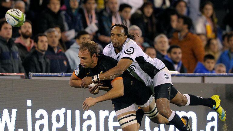 Sharks' wing Odwa Ndungane (top) vies for the ball with Jaguares' number 8 Leonardo Senatore