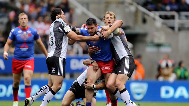 Widnes players try to stop Salford's Justin Carney at St James' Park