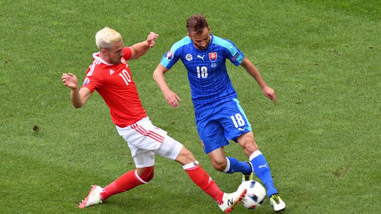 Wales' midfielder Aaron Ramsey vies for the ball against Slovakia's midfielder Miroslav Stoch
