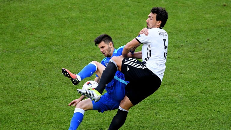 Michal Duris (left) competes for the ball with Germany's Mats Hummels