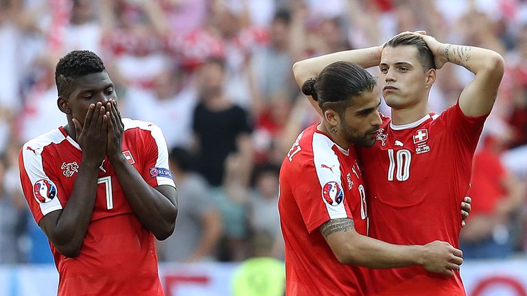 Xhaka (R) reacts after missing a vital penalty for Switzerland