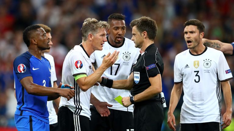 Bastian Schweinsteiger remonstrates with referee Nicola Rizzoli after his decision to award France a penalty