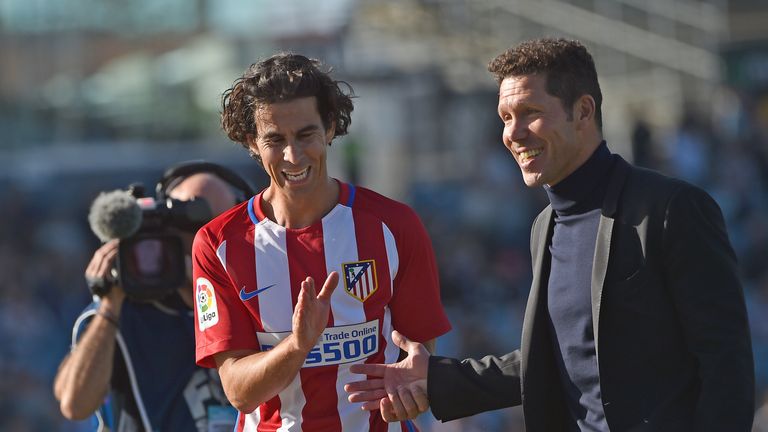 A relaxed Diego Simeone (right) shares a joke with midfielder Tiago (left)