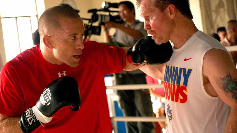 Boxing trainer Freddie Roach (R) puts Georges St-Pierre (L) through his paces