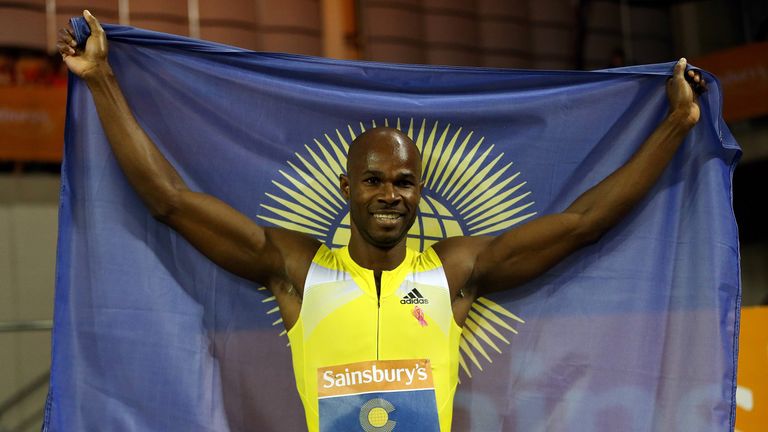 Kim Collins of Saint Kitts and Nevis celebrates a victory at the Emirates Arena in Glasgow