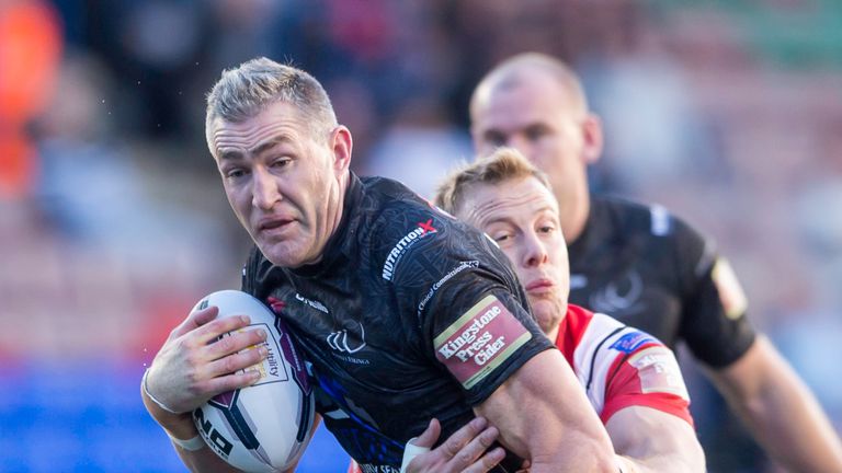 Widnes' Chris Houston is tackled by Salford's Craig Kopczak