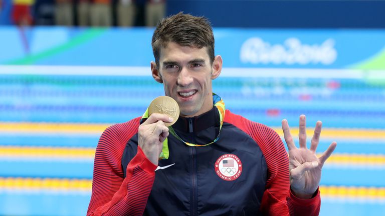 Michael Phelps celebrates winning another gold medal