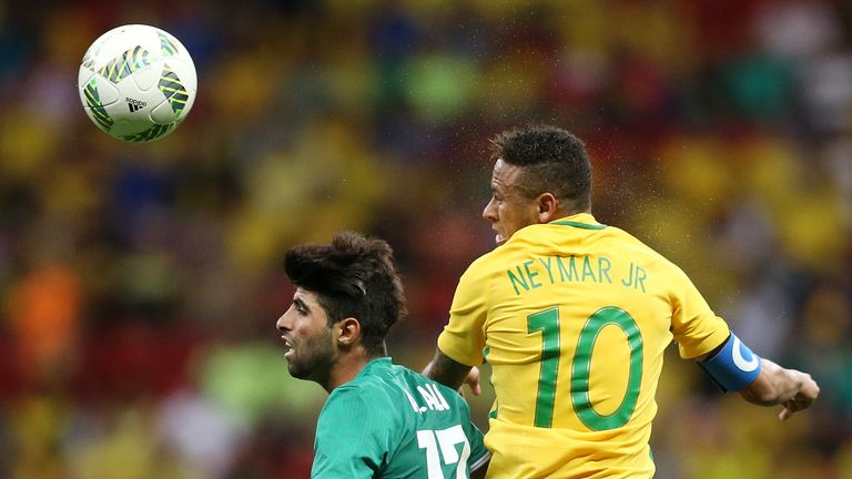 Neymar and Alaa Ali of Iraq battle for the ball in Brasilia