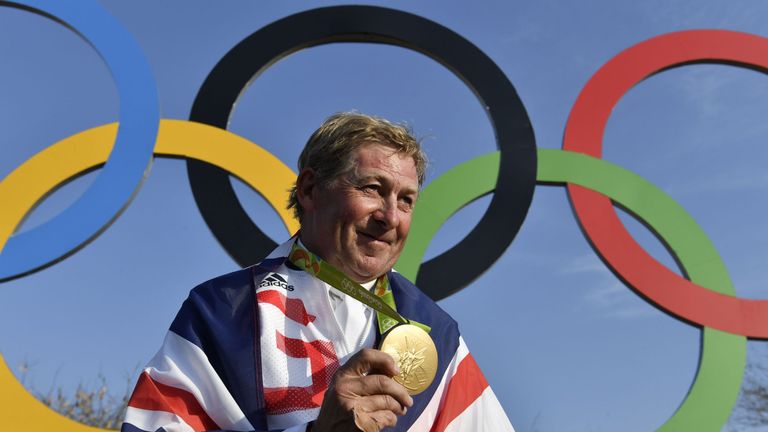 Britain's Nick Skelton celebrates with his gold medal