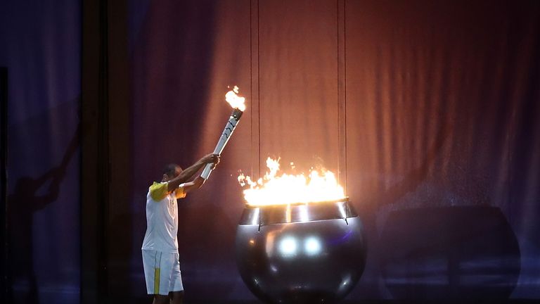The Olympic Cauldron is lit by the final torch bearer and former marathon runner Vanderlei Cordeiro de Lima