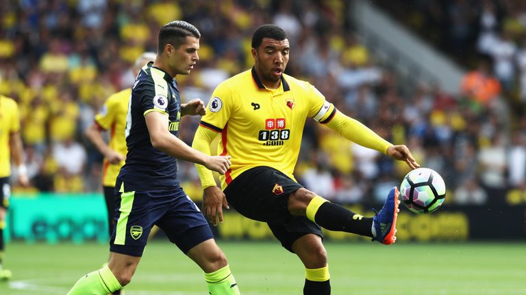 Troy Deeney of Watford controls the ball infront of Granit Xhaka