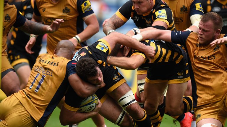 Alex Rieder of Wasps is tackled by Tom Varndell of Bristol