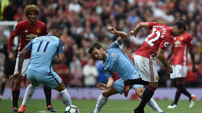 Henrikh Mkhitaryan (right) was substituted at the break during the derby